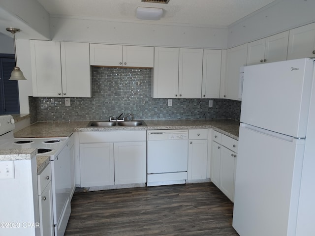 kitchen with backsplash, white appliances, sink, white cabinets, and dark hardwood / wood-style flooring