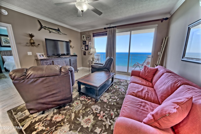 living room featuring a water view, ornamental molding, and ceiling fan