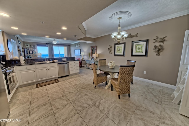 tiled dining area featuring a textured ceiling, crown molding, ceiling fan with notable chandelier, and sink