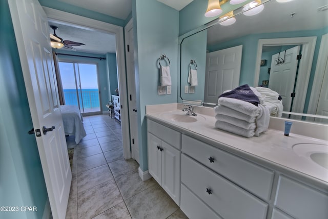 bathroom featuring dual vanity, tile floors, ceiling fan, and a water view