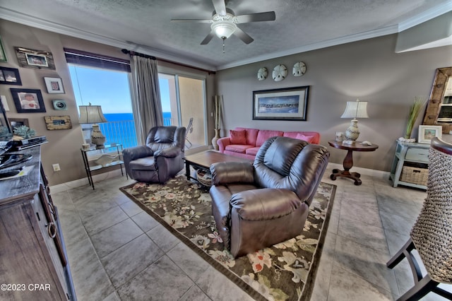 tiled living room with a textured ceiling, crown molding, and ceiling fan