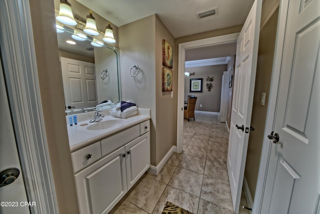 bathroom featuring a textured ceiling, tile floors, and vanity