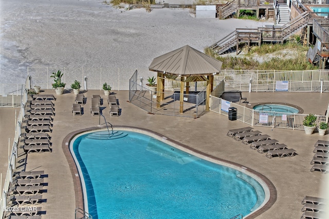 view of pool featuring a patio, a gazebo, and a hot tub