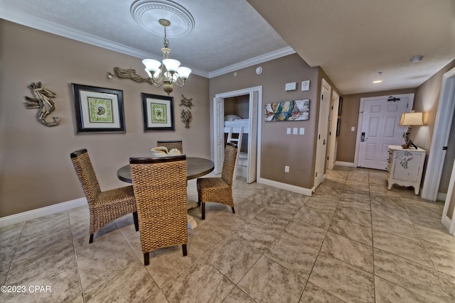 tiled dining room with ornamental molding, a textured ceiling, and an inviting chandelier