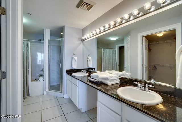 bathroom with double sink vanity, tile flooring, and walk in shower