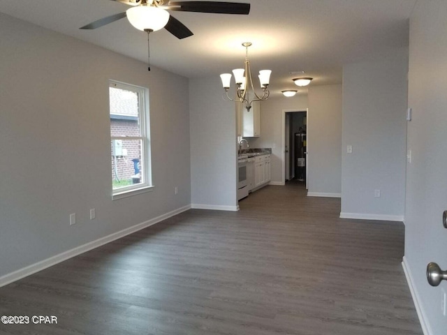 spare room with sink, ceiling fan with notable chandelier, and dark hardwood / wood-style flooring