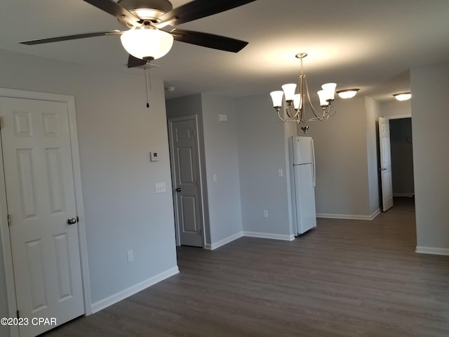 unfurnished room with dark hardwood / wood-style floors and ceiling fan with notable chandelier