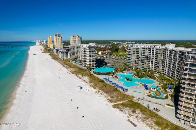 drone / aerial view with a beach view and a water view