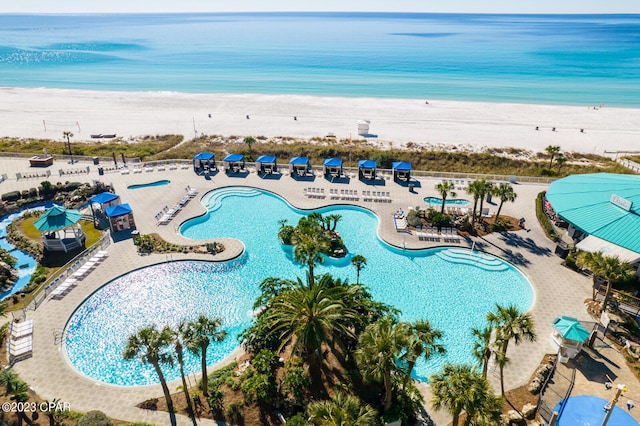 drone / aerial view with a beach view and a water view