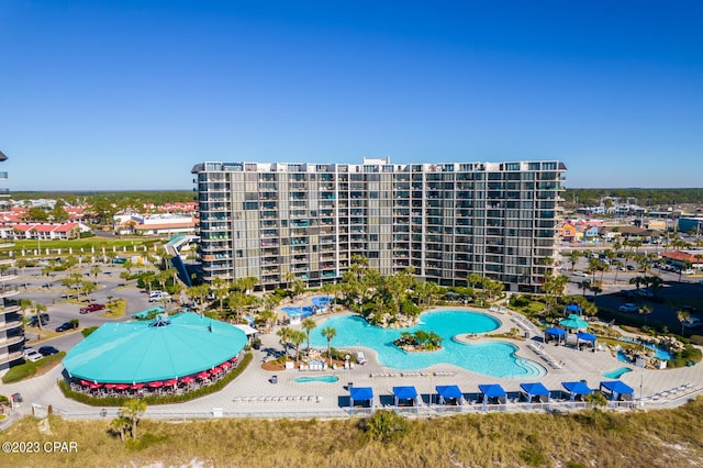 view of building exterior featuring a community pool