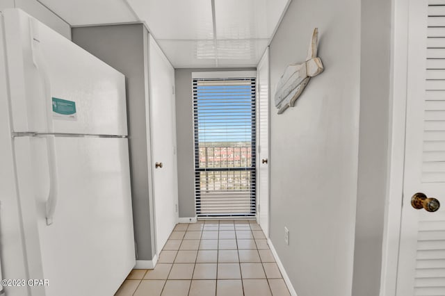 hall featuring light tile floors