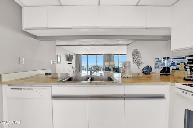 kitchen with white cabinets, white appliances, and sink