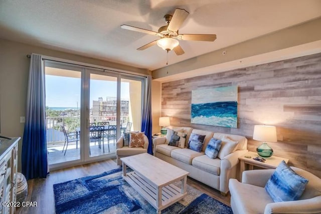 living room with ceiling fan and wood-type flooring