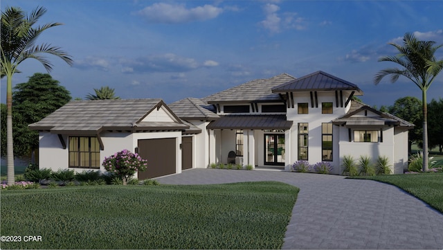 view of front of home with a front lawn and a garage