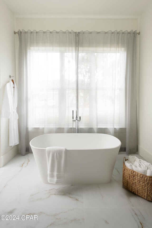 bathroom with plenty of natural light and tile flooring