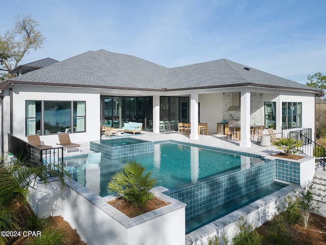 exterior space featuring a pool with hot tub and a patio area