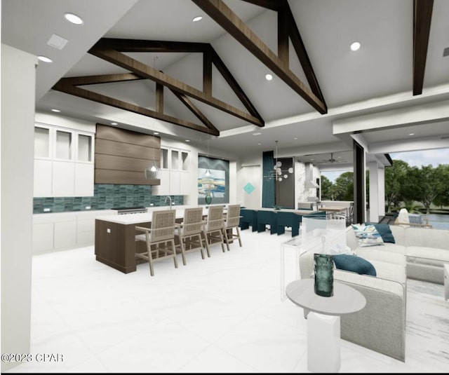 kitchen with premium range hood, beam ceiling, tasteful backsplash, a center island with sink, and a breakfast bar area