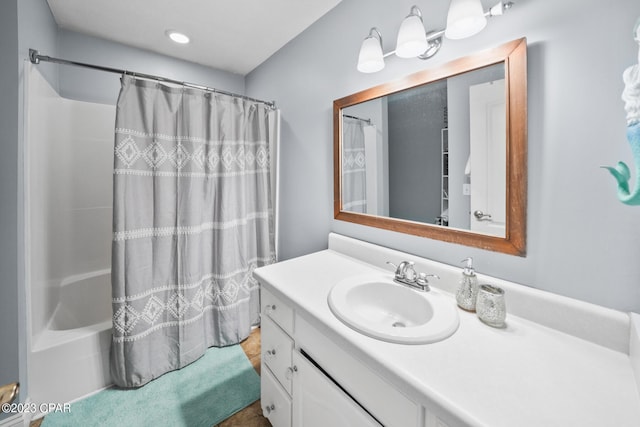 bathroom with large vanity and shower / tub combo