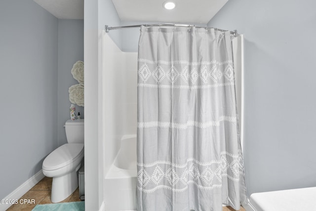 bathroom with tile flooring and toilet