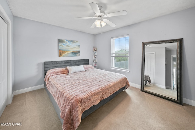 bedroom featuring light carpet and ceiling fan