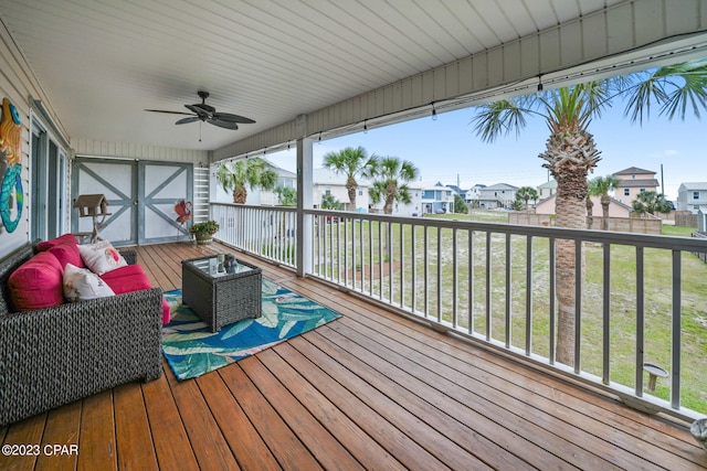 wooden terrace with a yard and ceiling fan