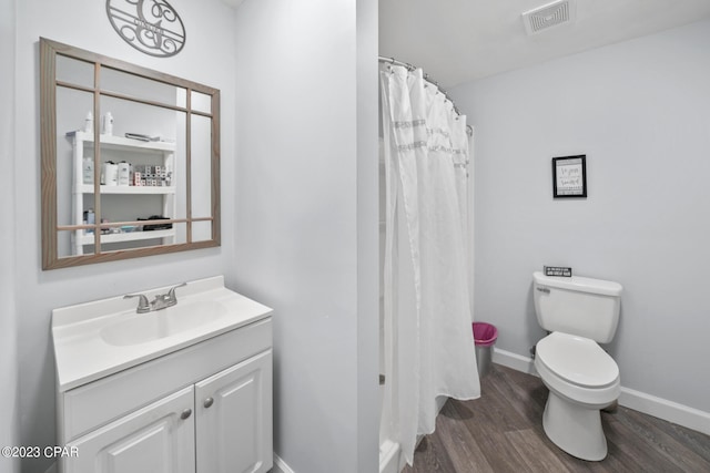 bathroom with oversized vanity, toilet, and wood-type flooring