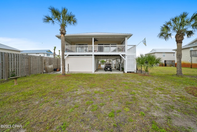 back of property with a lawn and a patio area