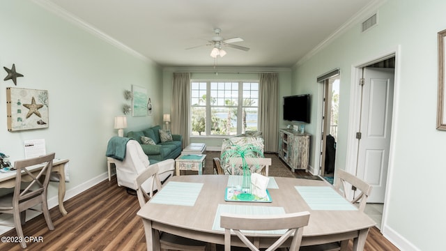 dining space with dark wood-type flooring, ceiling fan, and crown molding