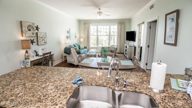 kitchen featuring sink, ceiling fan, dark wood-type flooring, and stone countertops