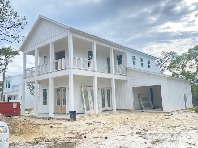 back of house with french doors and a balcony