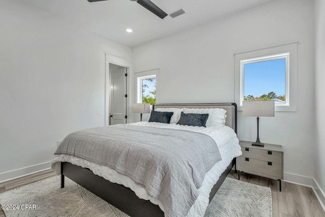 bedroom with light hardwood / wood-style floors and ceiling fan