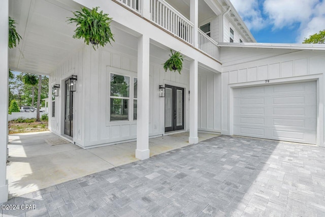 doorway to property with a garage and a balcony