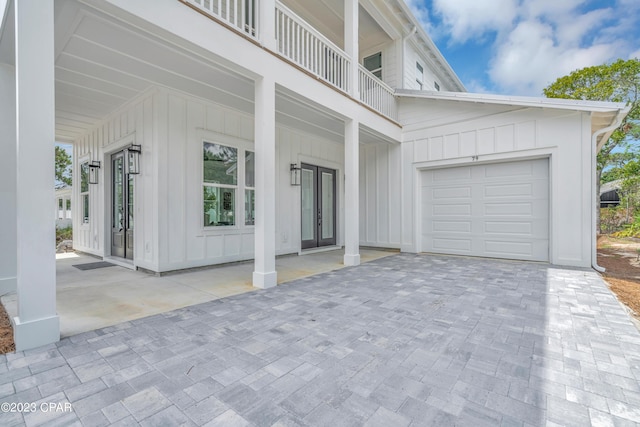 exterior space featuring a garage and a balcony