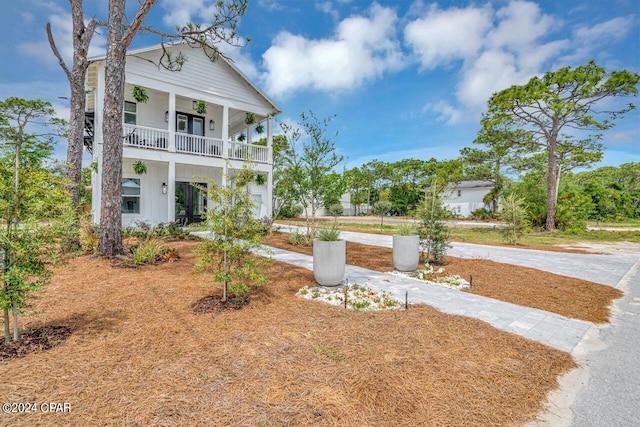 view of front of home with a balcony and covered porch