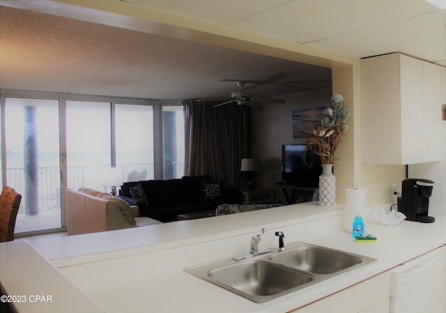 kitchen with white cabinetry, sink, ceiling fan, and dishwasher