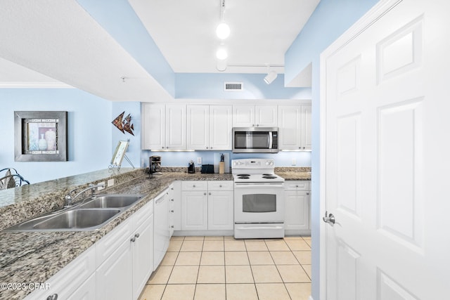 kitchen with visible vents, a sink, white cabinetry, white appliances, and light tile patterned floors