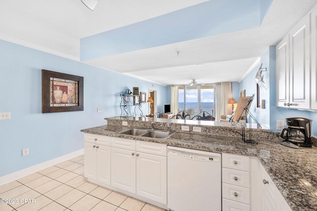 kitchen with a sink, white cabinets, crown molding, and white dishwasher