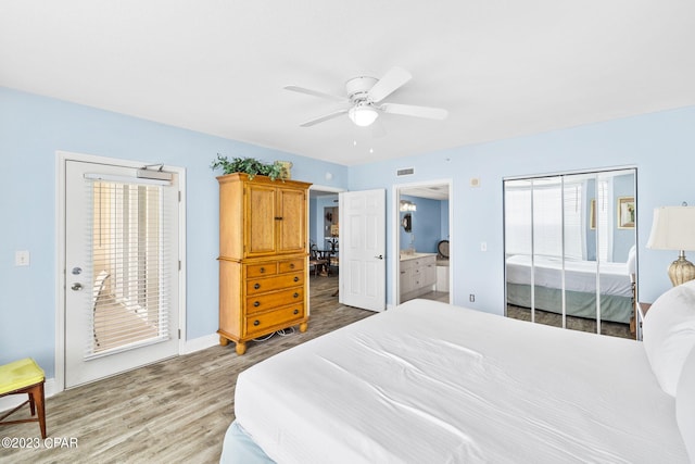 bedroom with visible vents, a ceiling fan, wood finished floors, connected bathroom, and baseboards