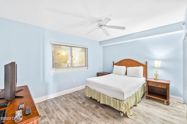 bedroom featuring ceiling fan, baseboards, and wood finished floors