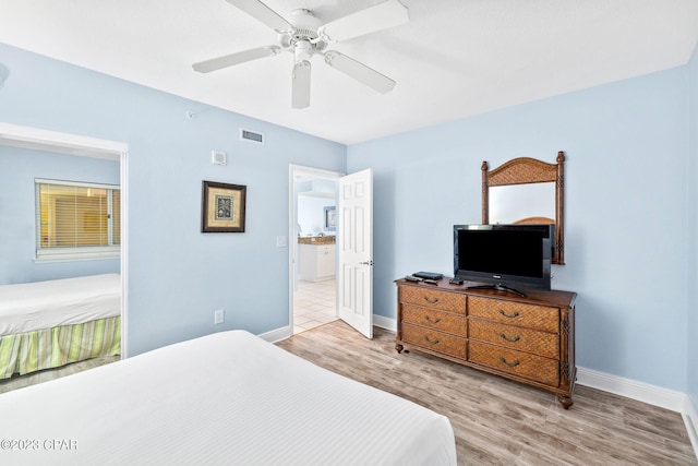 bedroom featuring visible vents, ceiling fan, baseboards, and wood finished floors