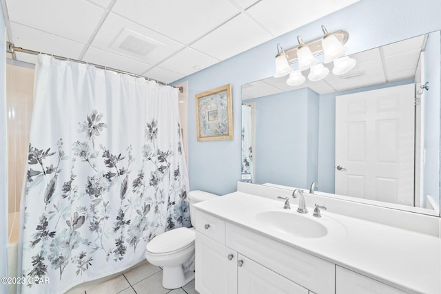 full bathroom with visible vents, a drop ceiling, toilet, tile patterned floors, and vanity