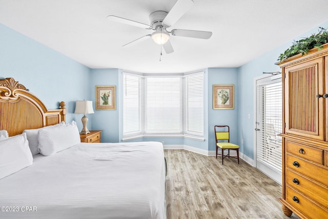 bedroom featuring light wood-type flooring, baseboards, and ceiling fan