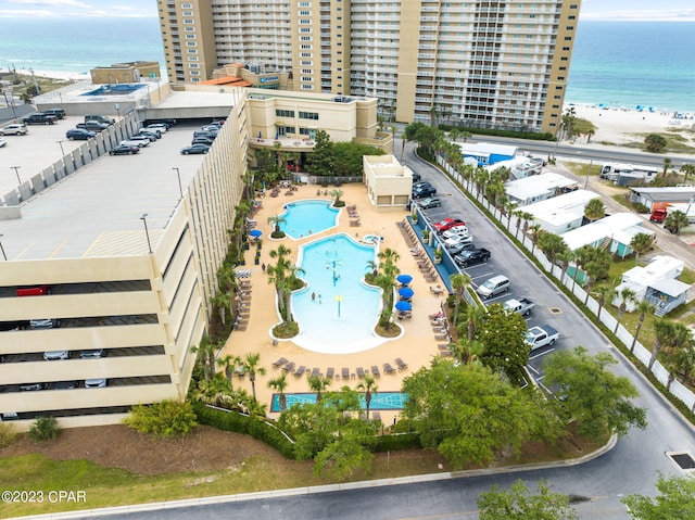 birds eye view of property with a water view and a beach view