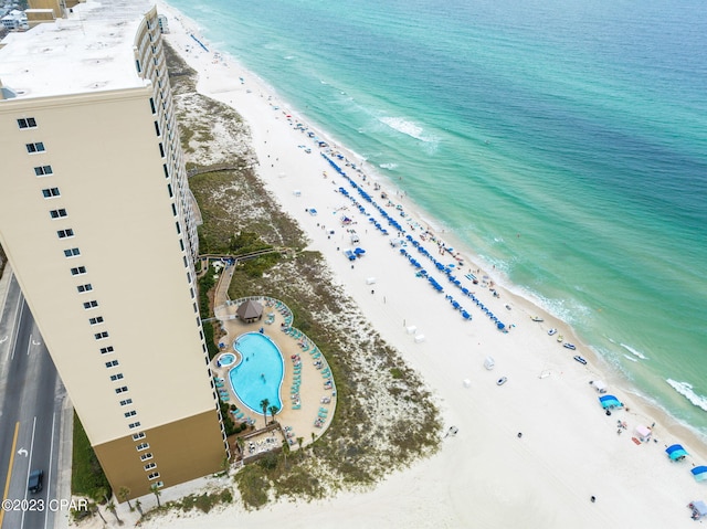 drone / aerial view featuring a water view and a view of the beach