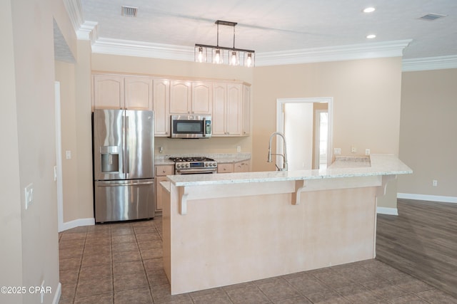 3522 Fox Run Blvd, Panama City, FL 32408 - kitchen featuring a breakfast bar, visible vents, ornamental molding, a peninsula, and appliances with stainless steel finishes