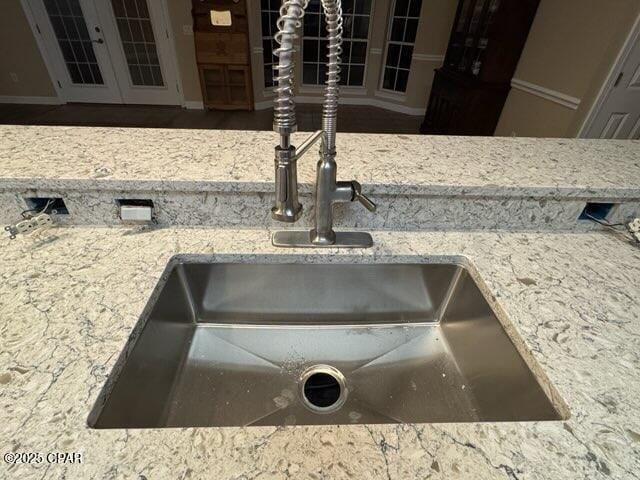 room details featuring a sink and light stone countertops