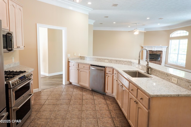 3522 Fox Run Blvd, Panama City, FL 32408 - kitchen featuring a ceiling fan, crown molding, a sink, stainless steel appliances, and a premium fireplace