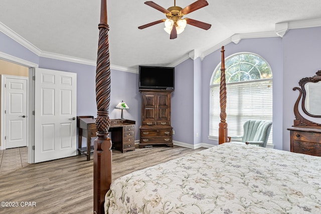 bedroom with baseboards, wood finished floors, ornamental molding, and vaulted ceiling