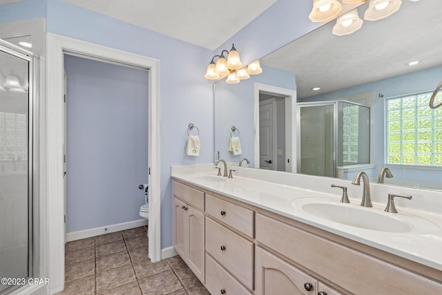 full bath featuring a sink, toilet, double vanity, and a shower stall