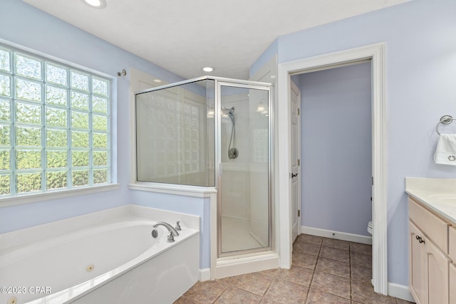 bathroom with a bath, plenty of natural light, a stall shower, and vanity